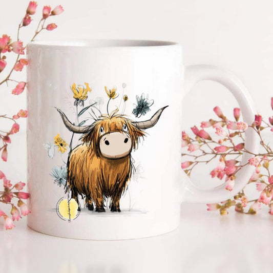 Mug with a cartoon highland cow design surrounded by pink flowers on a white background