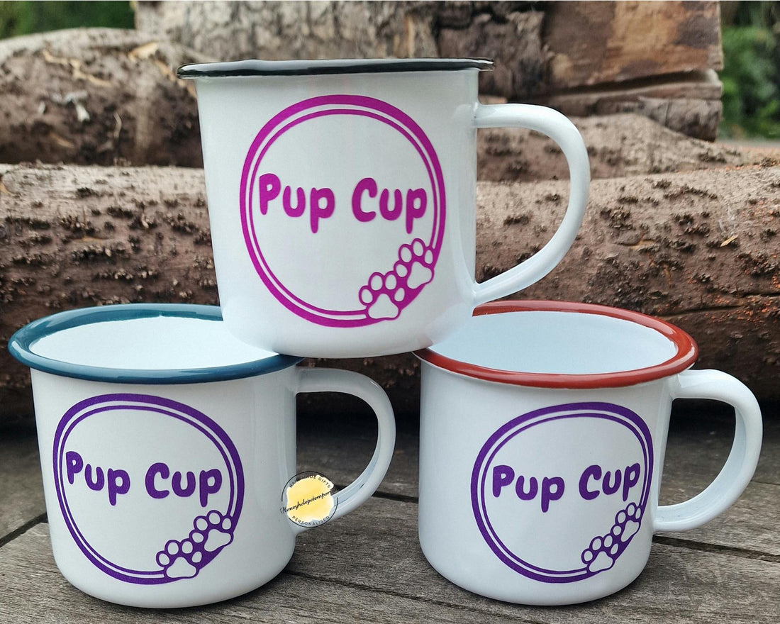 Set of 'Pup Cup' mugs on a wooden surface with a natural background